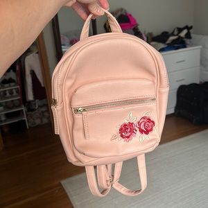 I am selling a pink mini leather backpack.